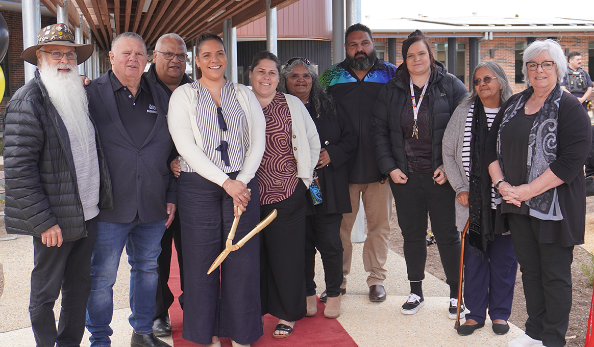 A group of people standing at the opening of a new health centre