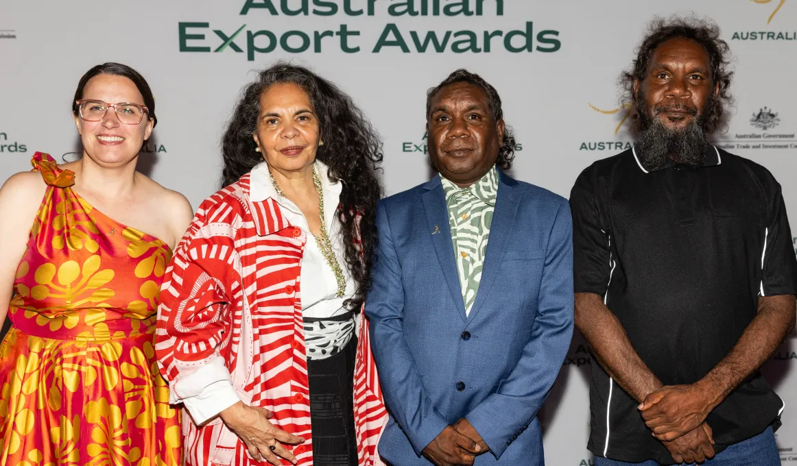 4 people stand in front of the Australian Export Awards