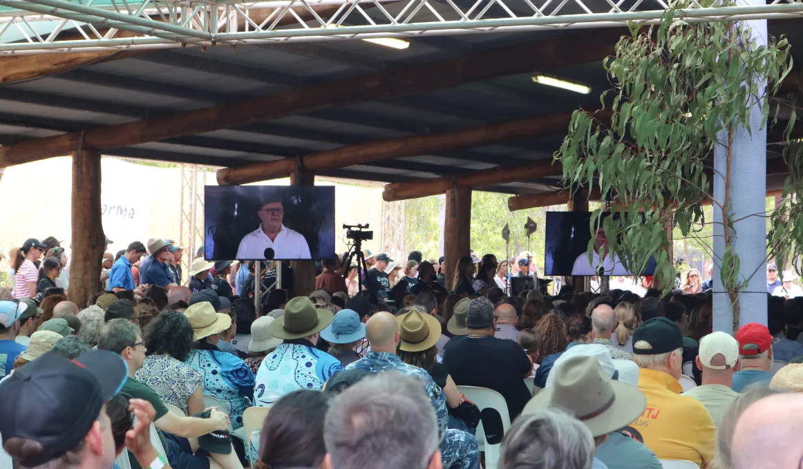 A crowd of people watching the Prime Minister deliver a speech at Garma Festival