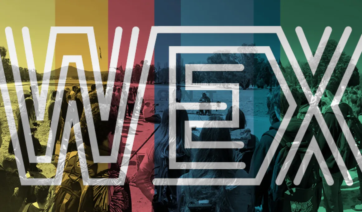 Many young people stand in semi-circle watching a ceremony. The image is overlayed with the colours yellow, red, blue and green and the word WEX with letters made from multiple white lines in parallel.