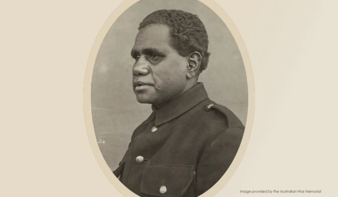 A portrait photo of an Indigenous man wearing a dark uniform buttoned up to the chin.