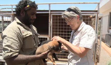 Vet and animal health worker holding a pup