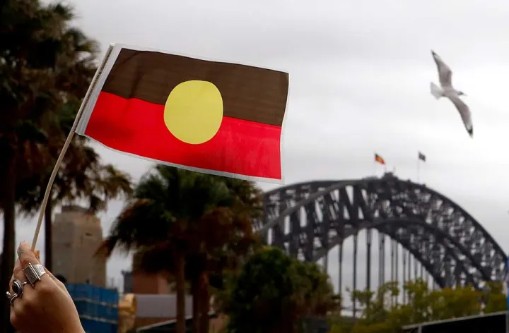 Aboriginal Flag with Sydney Harbour Bridge. Credit: AAP/Daniel Munoz