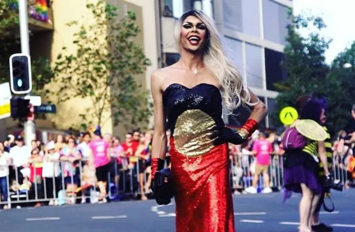 Aboriginal drag queen Felicia Foxx wears a sequined dress in red, black, yellow colours at the Sydney Mardi Gras. Credit: Barbara McGrady