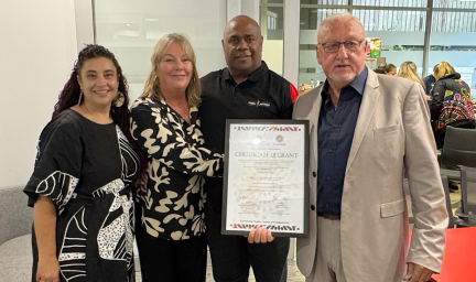 Four people accept an award