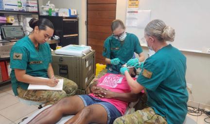 Three army dentists working on a patient