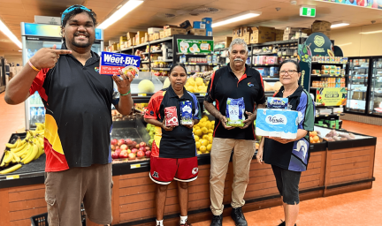 People hold common items up in a supermarket